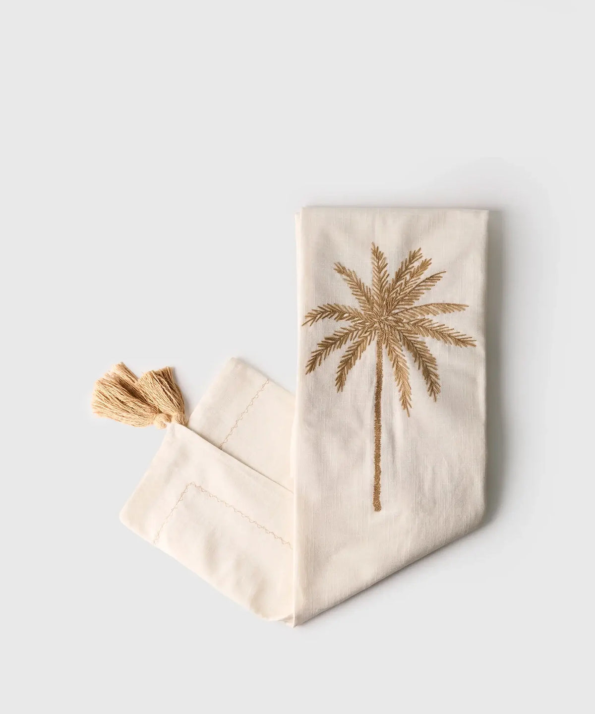 Manta Palmeras Bordadas de algodón con bordado de palmeras y tassel, marca Lounge en tamaño 120 x 230 cm.
