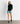 Mujer usando Polerón Primera Capa Active de Lounge con shorts azules, ideal para actividades al aire libre.