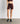 Short Deportivo Biker Unicolor Active de Lounge en color marrón, con pretina cruzada y bolsillo lateral.
