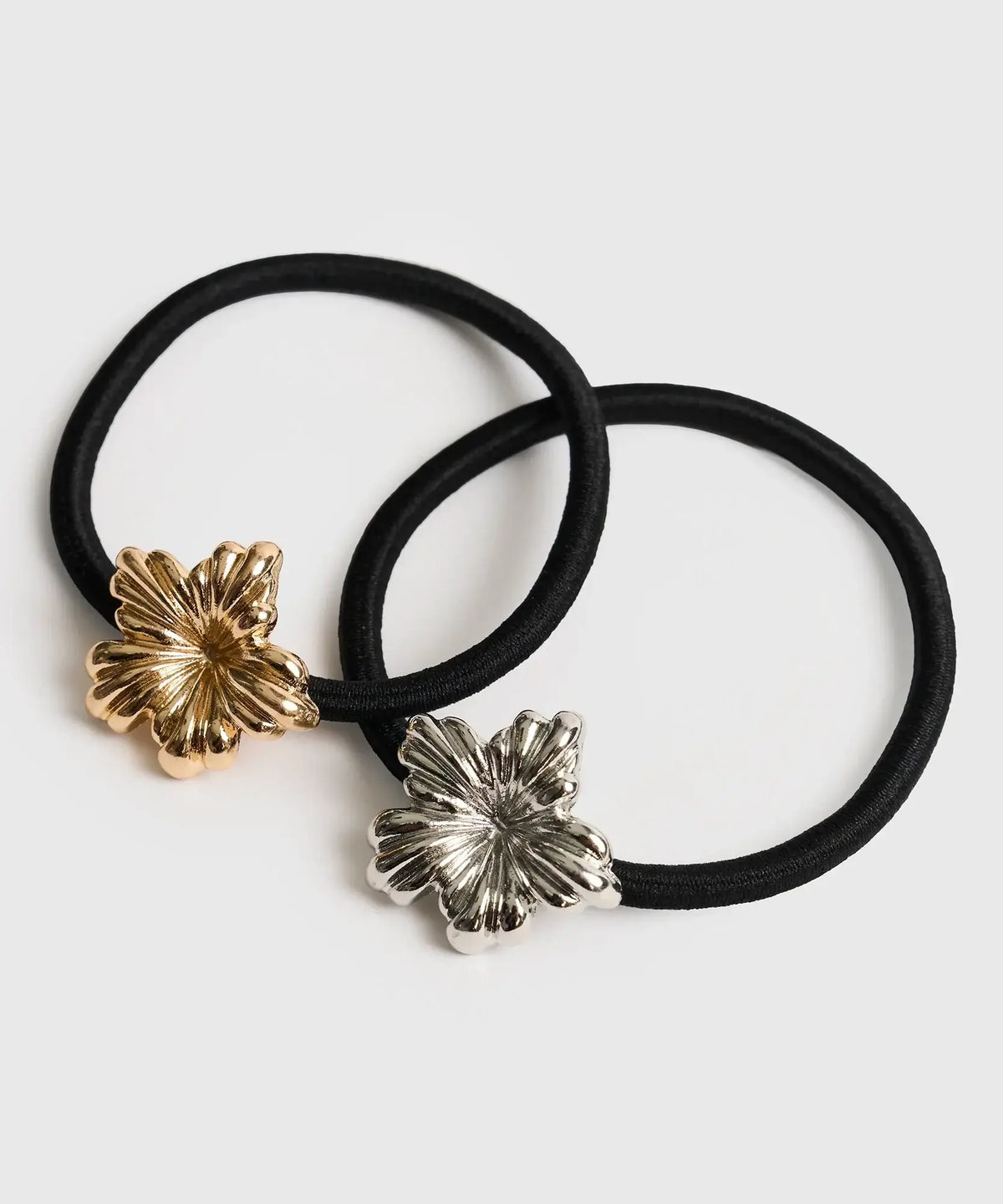 Set Collets Detalle Metal de Lounge, un set de dos collets elásticos negros con dijes de flores metálicas en color dorado y plateado.