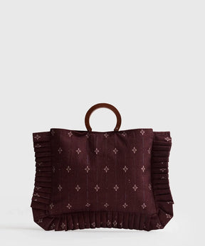 Mini Cartera Vuelos Paradiso de Lounge, cartera práctica y elegante con bolsillo y asas de madera.