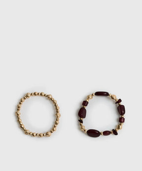 Set Pulseras Mostacillas Bicolor de Lounge, conjunto de pulseras elásticas con mostacillas en tonos dorado y burdeos.