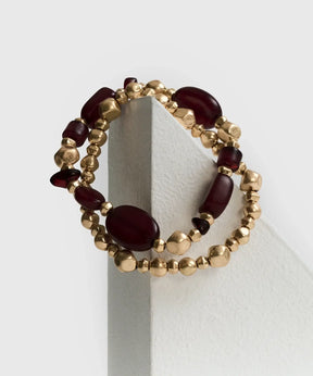 Set Pulseras Mostacillas Bicolor de Lounge, dos pulseras elásticas con mostacillas en tonos dorado y burdeos.