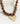 Collar Charm Street de Lounge con piedras marrones y colgante metálico dorado en forma de corazón.