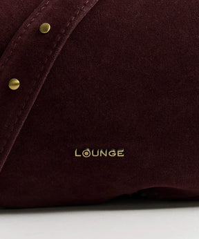 Cartera Bandolera Fake Suede Boheme de Lounge con detalle de tachas y logotipo dorado.
