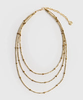 Collar Mostacillas Woman de Lounge, collar dorado de tres capas con delicadas mostacillas pequeñas.